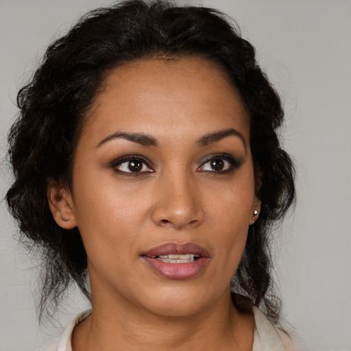 Joyful latino young-adult female with medium  brown hair and brown eyes