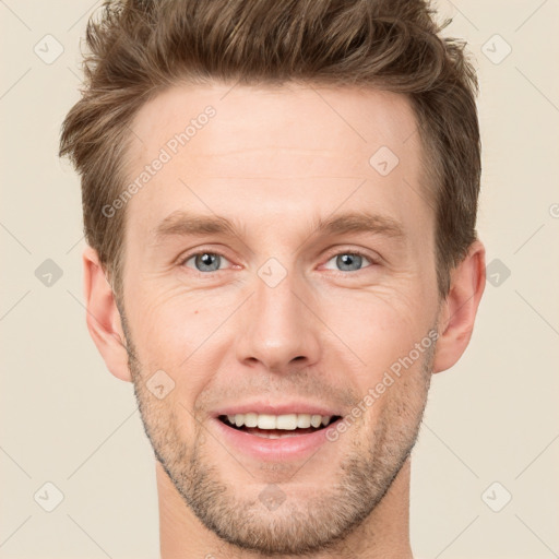 Joyful white young-adult male with short  brown hair and grey eyes