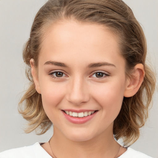 Joyful white child female with medium  brown hair and brown eyes