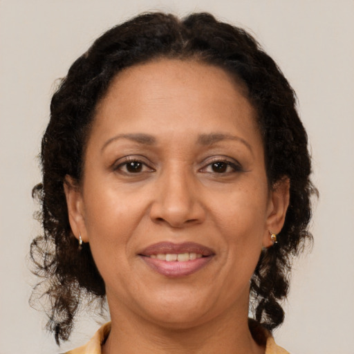 Joyful latino adult female with medium  brown hair and brown eyes