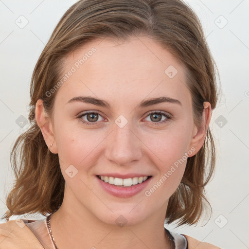 Joyful white young-adult female with medium  brown hair and blue eyes