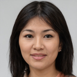 Joyful asian young-adult female with medium  brown hair and brown eyes