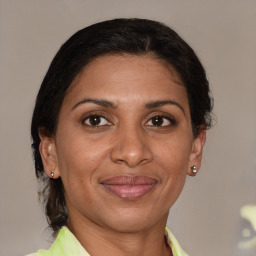 Joyful white adult female with medium  brown hair and brown eyes