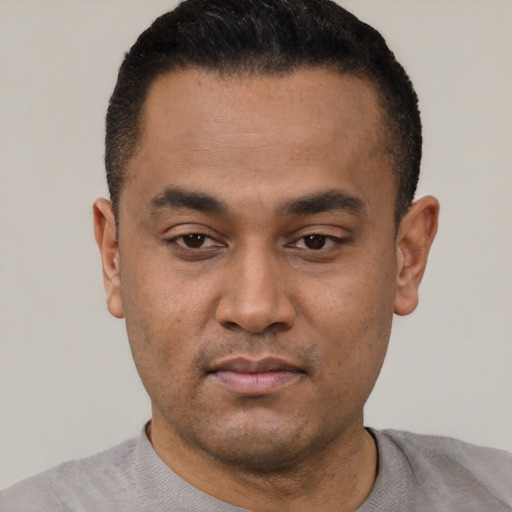 Neutral latino young-adult male with short  black hair and brown eyes