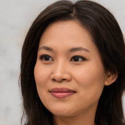 Joyful asian young-adult female with long  brown hair and brown eyes