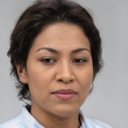 Joyful asian adult female with medium  brown hair and brown eyes