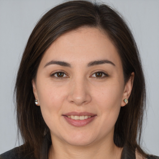 Joyful white young-adult female with long  brown hair and brown eyes