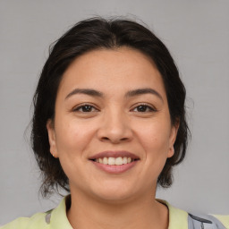 Joyful latino young-adult female with medium  brown hair and brown eyes