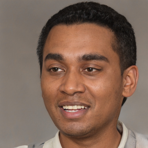 Joyful black young-adult male with short  black hair and brown eyes
