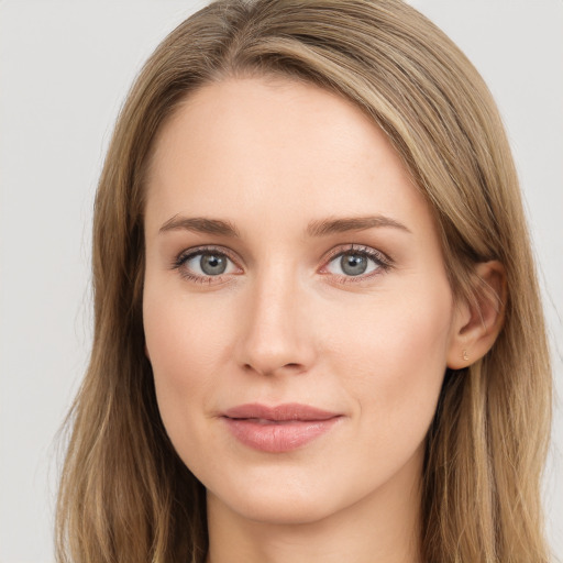 Joyful white young-adult female with long  brown hair and green eyes