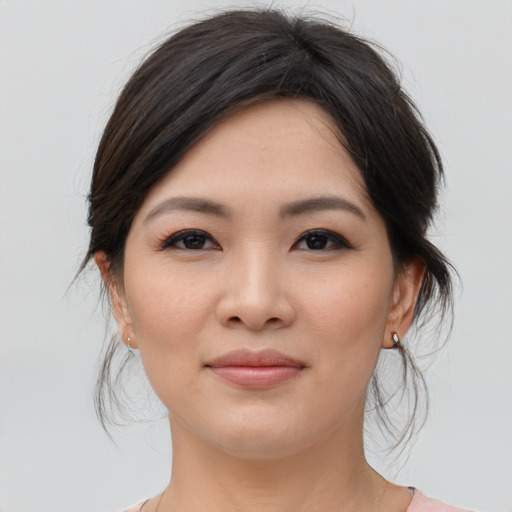 Joyful asian young-adult female with medium  brown hair and brown eyes