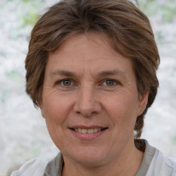 Joyful white adult female with medium  brown hair and grey eyes