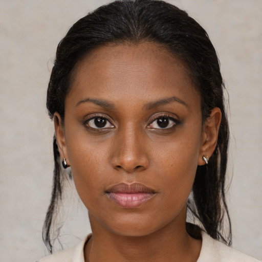 Neutral black young-adult female with medium  brown hair and brown eyes