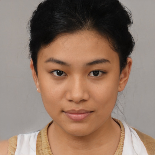 Joyful asian young-adult female with short  brown hair and brown eyes