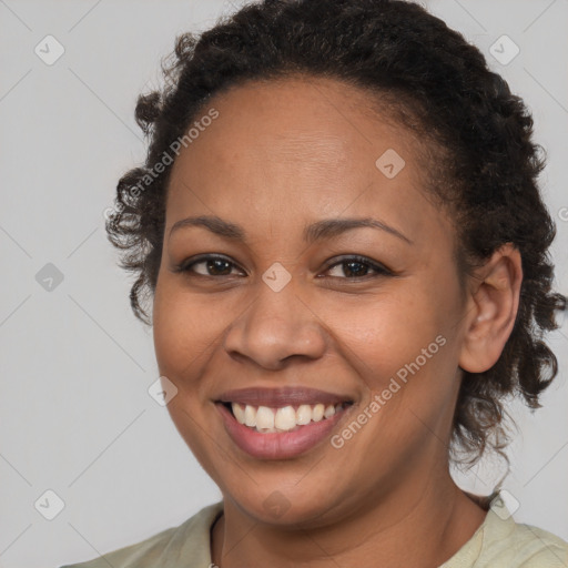 Joyful black young-adult female with medium  brown hair and brown eyes