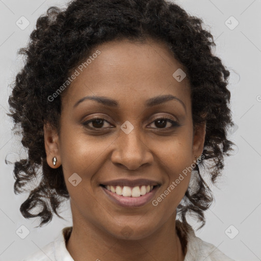 Joyful black young-adult female with medium  brown hair and brown eyes