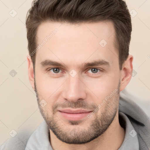 Joyful white young-adult male with short  brown hair and brown eyes