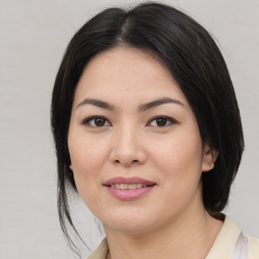 Joyful asian young-adult female with medium  brown hair and brown eyes
