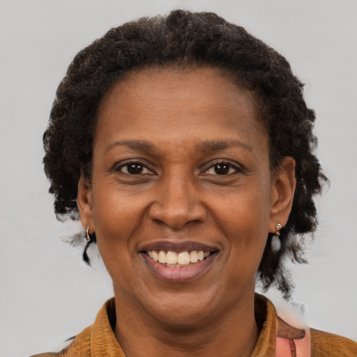 Joyful black adult female with short  brown hair and brown eyes