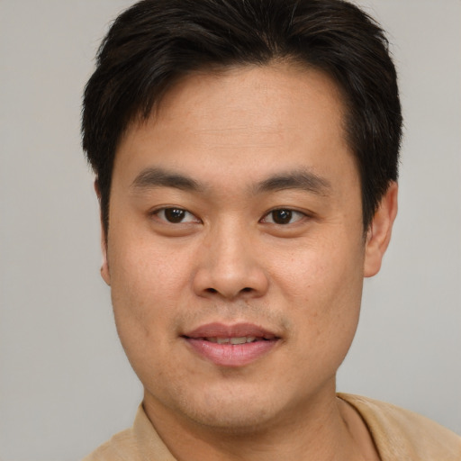 Joyful white young-adult male with short  brown hair and brown eyes