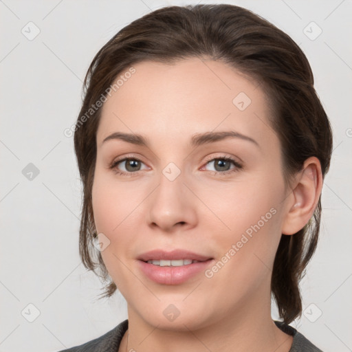 Joyful white young-adult female with medium  brown hair and grey eyes