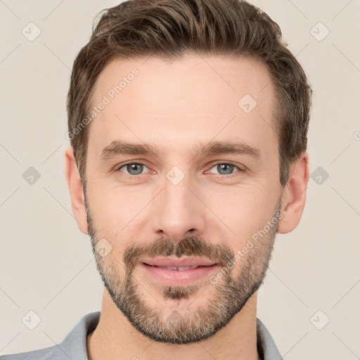 Joyful white young-adult male with short  brown hair and grey eyes