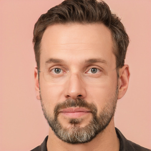 Joyful white adult male with short  brown hair and brown eyes