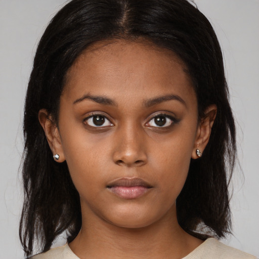 Neutral black young-adult female with medium  brown hair and brown eyes