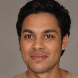 Joyful latino young-adult male with short  brown hair and brown eyes