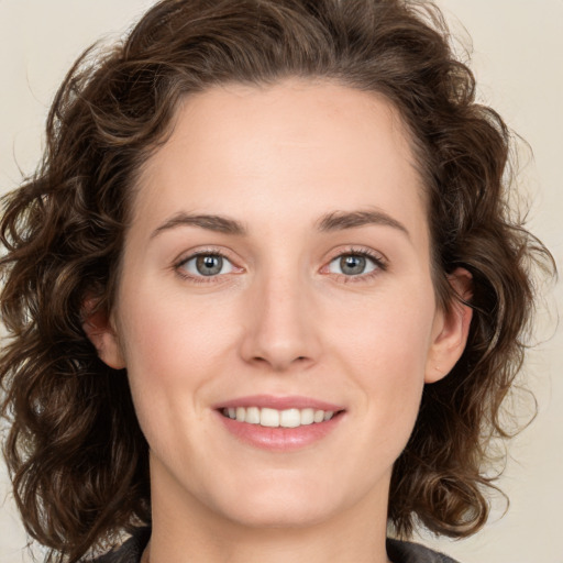 Joyful white young-adult female with medium  brown hair and green eyes