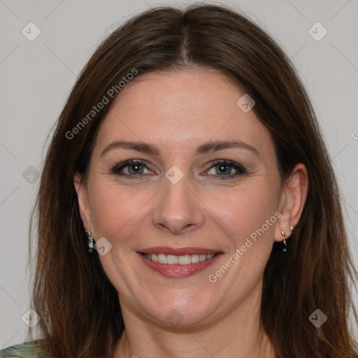 Joyful white adult female with long  brown hair and brown eyes