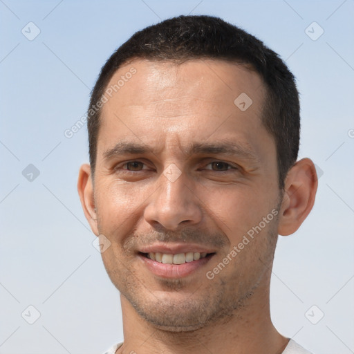 Joyful white adult male with short  brown hair and brown eyes