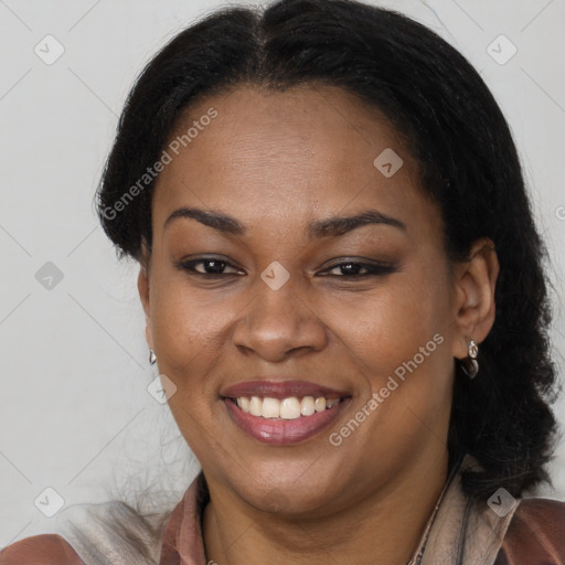 Joyful black adult female with long  brown hair and brown eyes