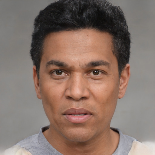 Neutral latino adult male with short  black hair and brown eyes
