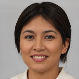 Joyful asian young-adult female with medium  brown hair and brown eyes