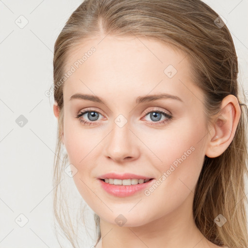 Joyful white young-adult female with long  brown hair and blue eyes