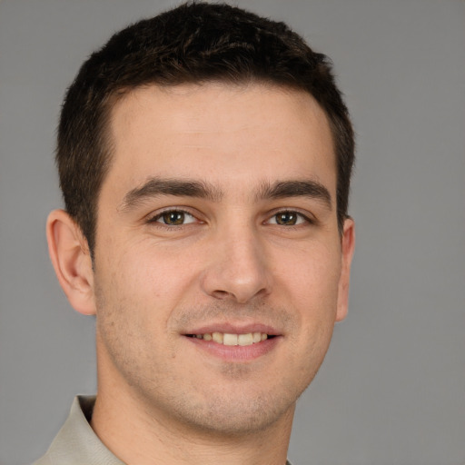 Joyful white young-adult male with short  brown hair and brown eyes