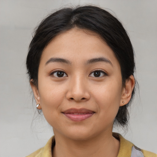 Joyful asian young-adult female with medium  black hair and brown eyes