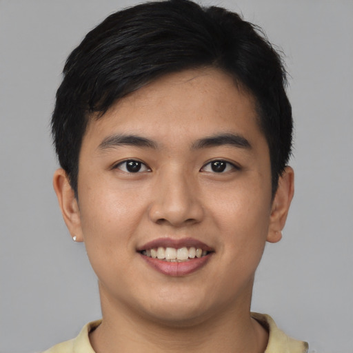 Joyful asian young-adult male with short  black hair and brown eyes