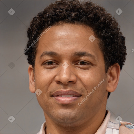 Joyful black young-adult male with short  brown hair and brown eyes