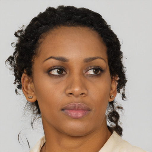 Neutral black young-adult female with long  brown hair and brown eyes
