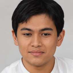 Joyful asian young-adult male with short  black hair and brown eyes