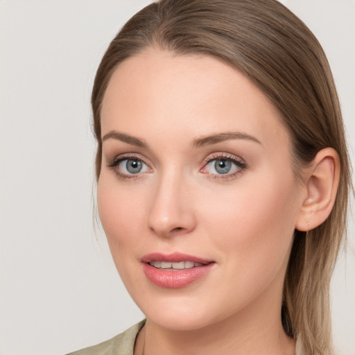 Joyful white young-adult female with long  brown hair and blue eyes