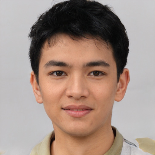 Joyful asian young-adult male with short  black hair and brown eyes