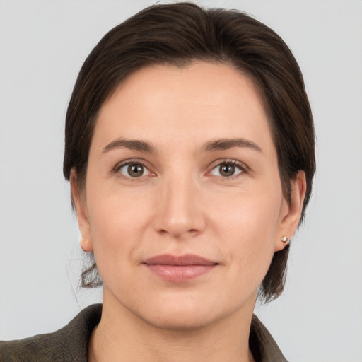 Joyful white young-adult female with medium  brown hair and brown eyes