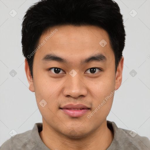 Joyful asian young-adult male with short  black hair and brown eyes