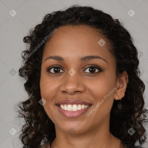 Joyful black young-adult female with medium  brown hair and brown eyes