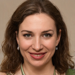 Joyful white young-adult female with medium  brown hair and green eyes