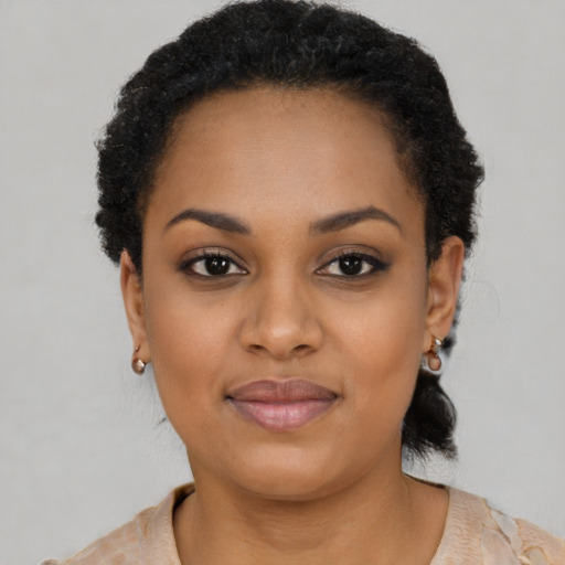 Joyful black young-adult female with short  black hair and brown eyes