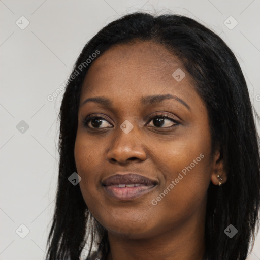 Joyful black young-adult female with long  black hair and brown eyes